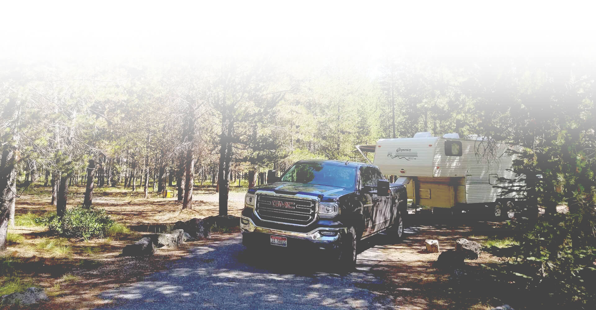 RV and truck in a campsite in the woods